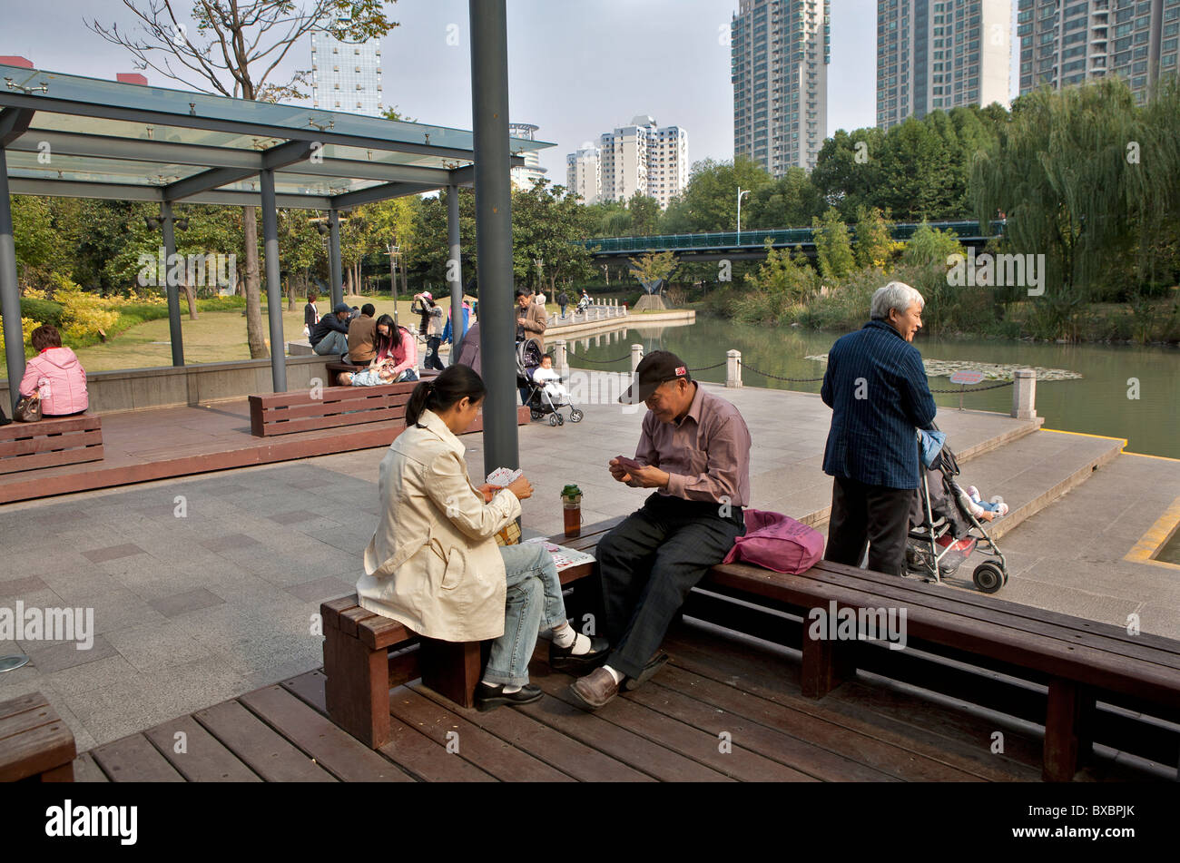 Man and woman playing cards at Xujiahui Park, Shanghai, China Stock Photo