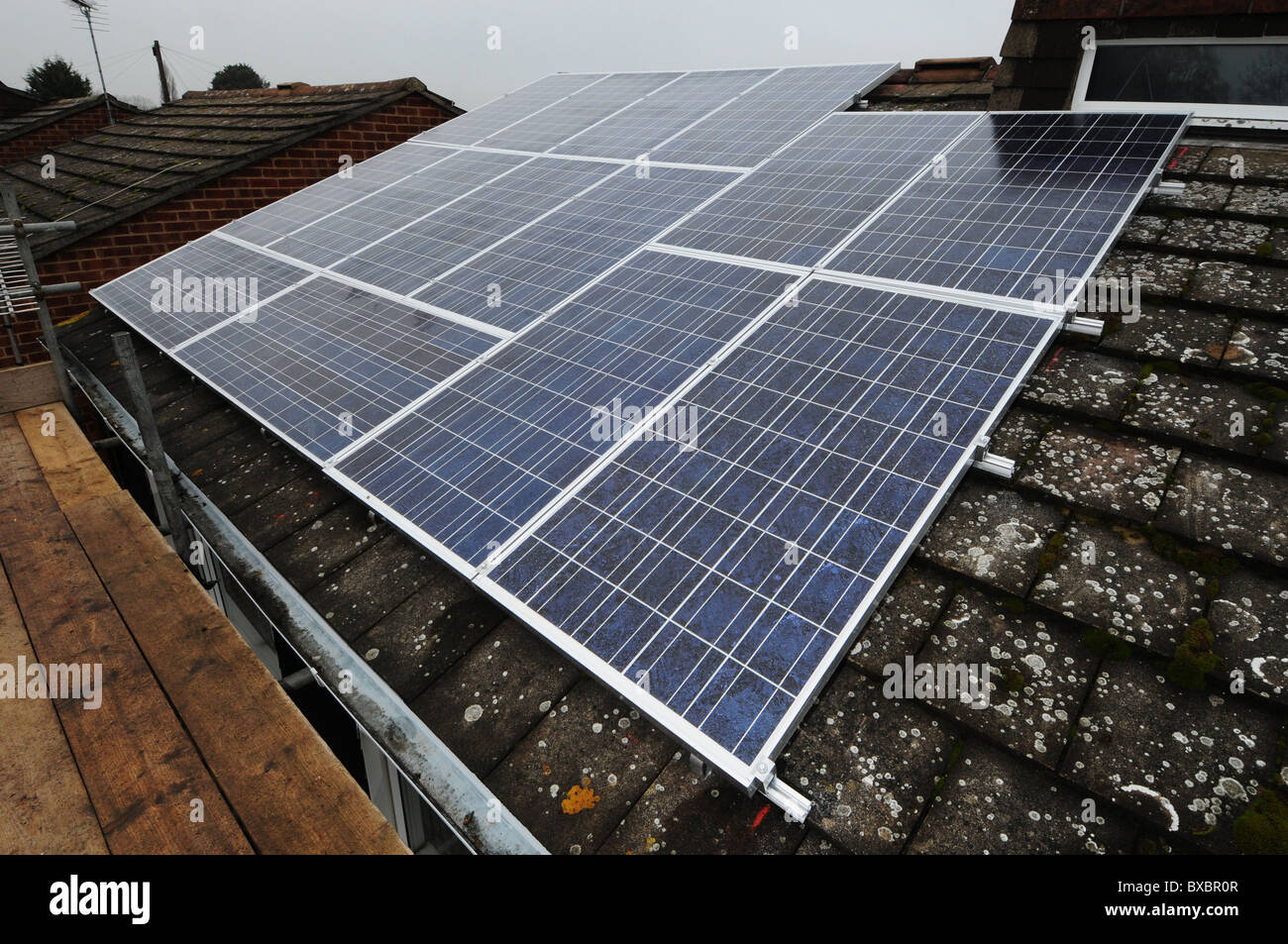 Solar panel installation showing the roof panels, inverter and internal equipment. Stock Photo