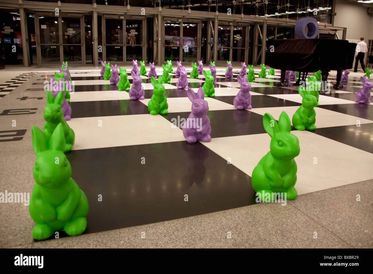 Plastic easter bunnies on a floor chessboard in Stary Browar, Poznan, Poland Stock Photo