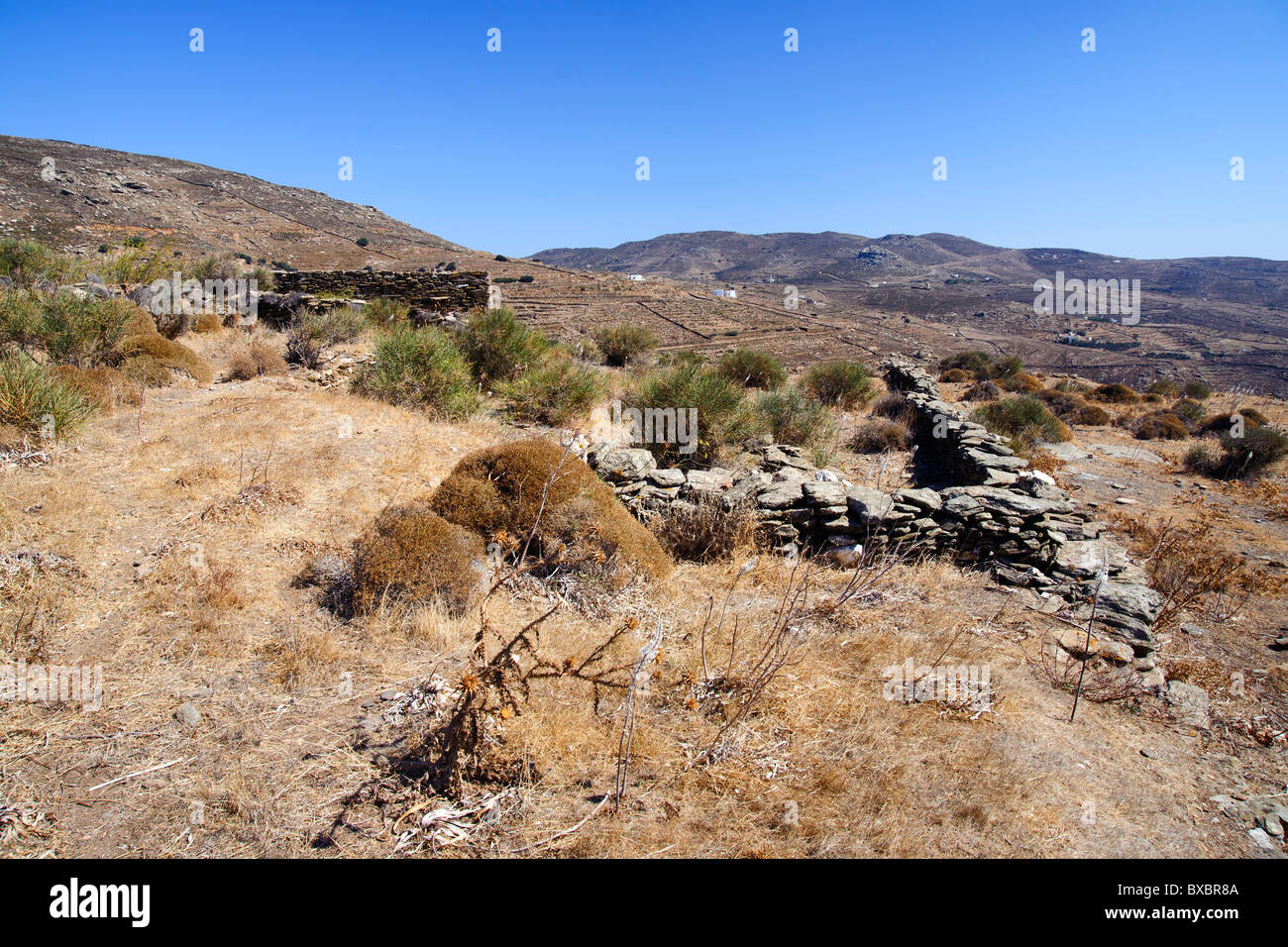 Remains of ancient stone buildings near Kardiani, on the Greek Cyclade island of Tinos. Stock Photo