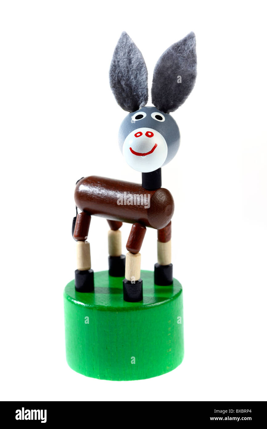 Children's toy, a  donkey, nodding donkey, played by fingers, moves up an down. Stock Photo
