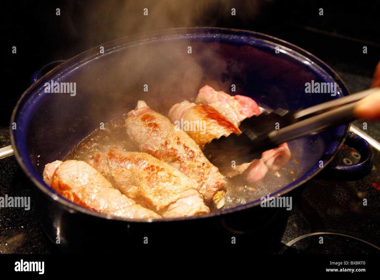 Beef roulades, fried in a roasting dish. Stock Photo