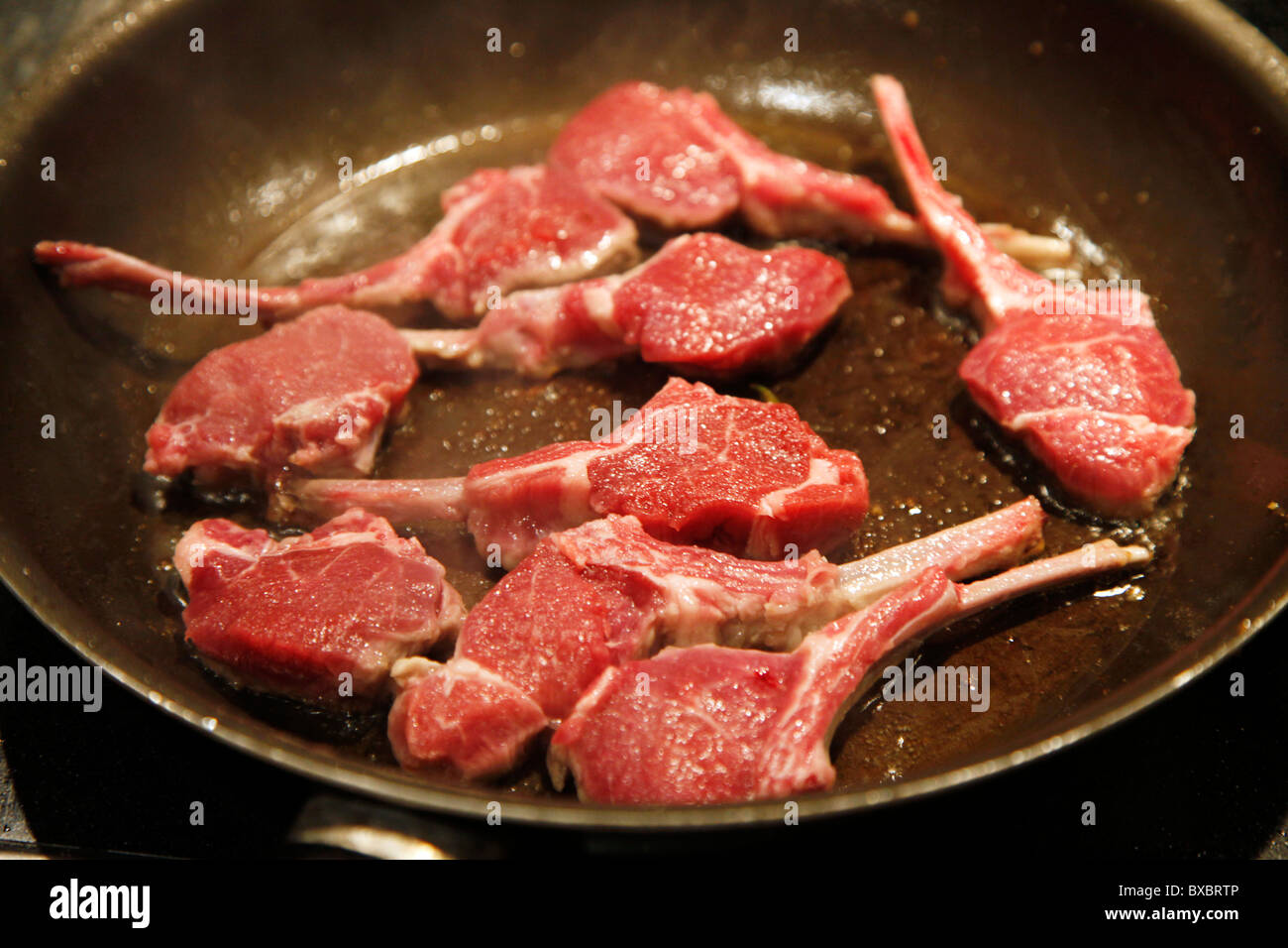 Lamb chops, frying in a pan. Stock Photo