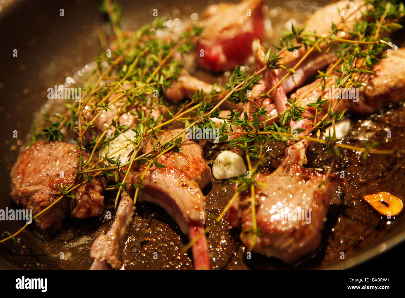 Lamb chops, frying in a pan with herbs, garlic Stock Photo - Alamy