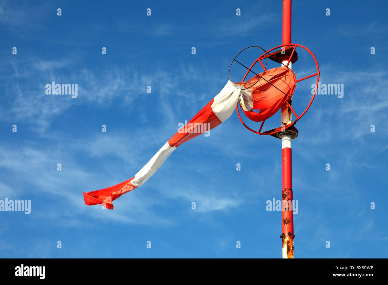 Red and white airbag at an airfield, during a low wind period. Stock Photo