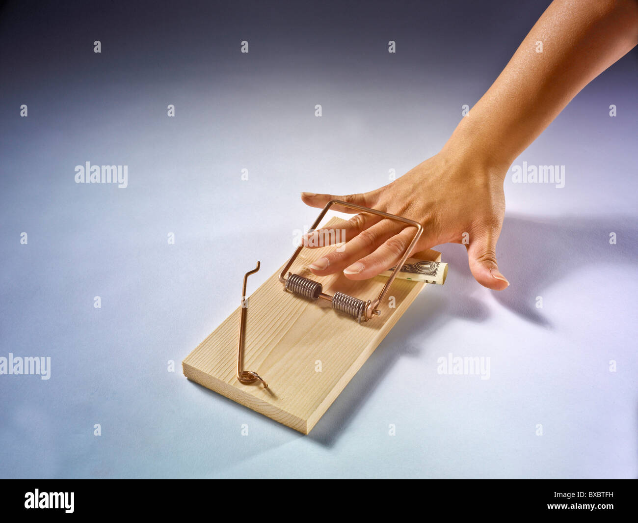 https://c8.alamy.com/comp/BXBTFH/hand-caught-restrained-removing-money-from-large-mouse-trap-BXBTFH.jpg