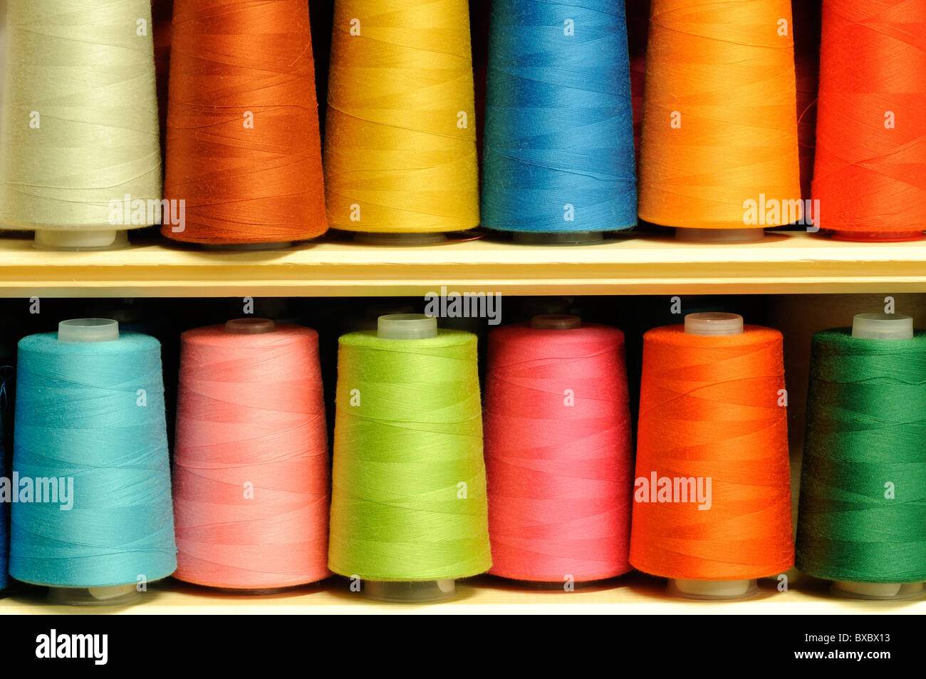 Group of multicolored sewing threads on shelf Stock Photo - Alamy