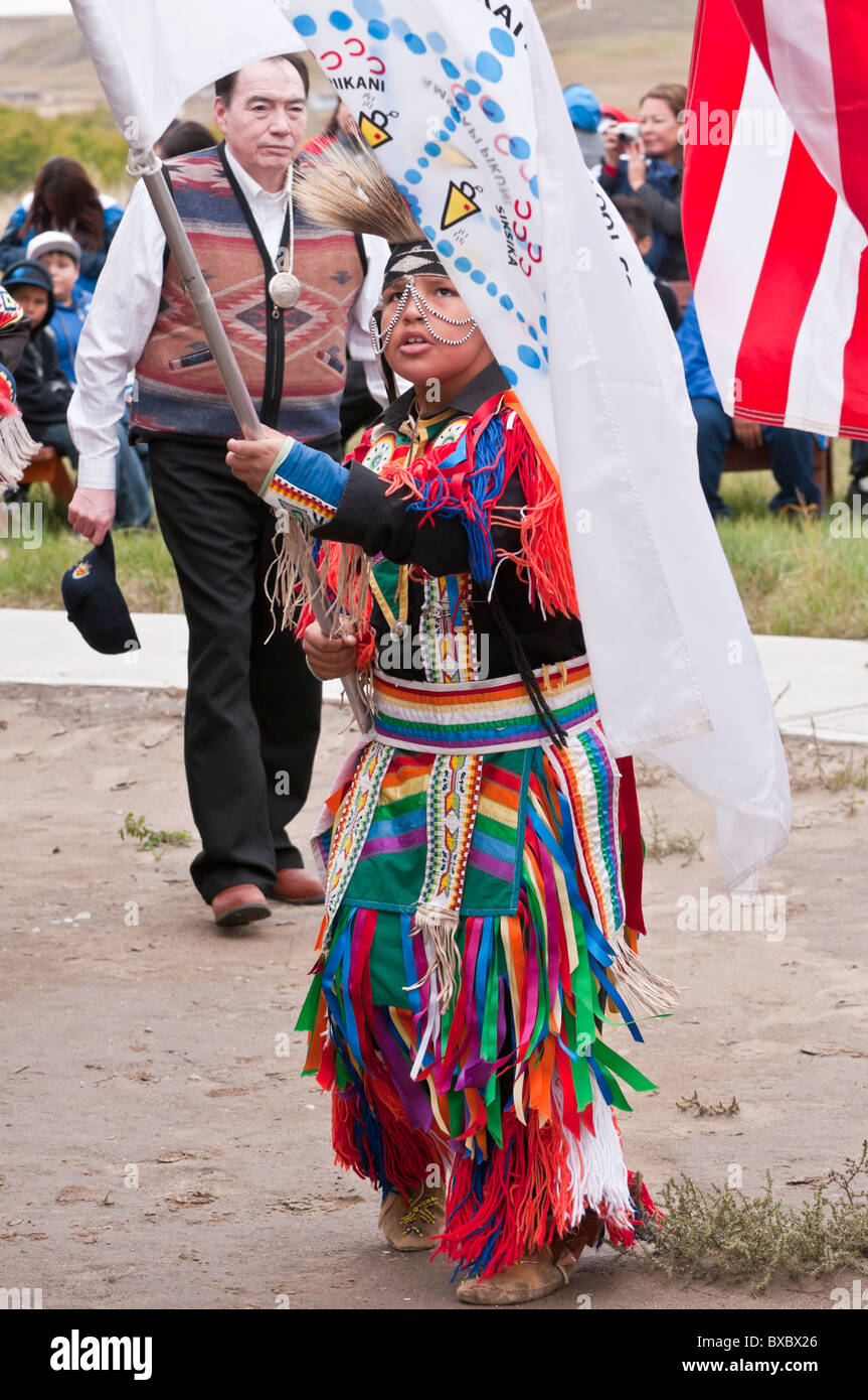 Grand Entry with flags, boy with Blackfoot Nation flag, at pow-wow, Blackfoot Crossing Historical Park, Alberta, Canada Stock Photo