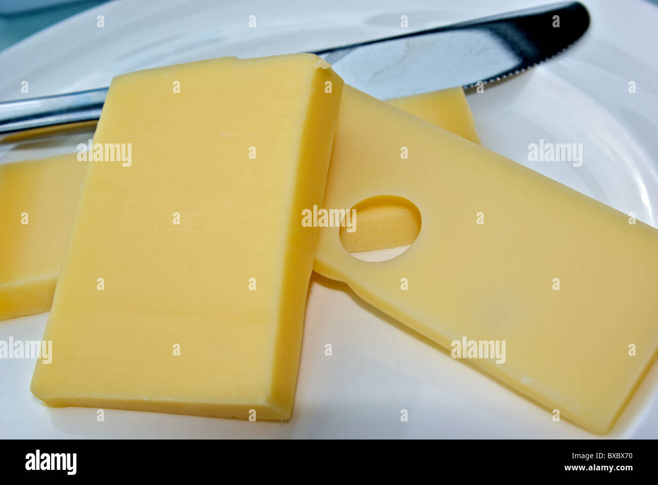 Cheese plate with three hard Swiss cheese slices Stock Photo