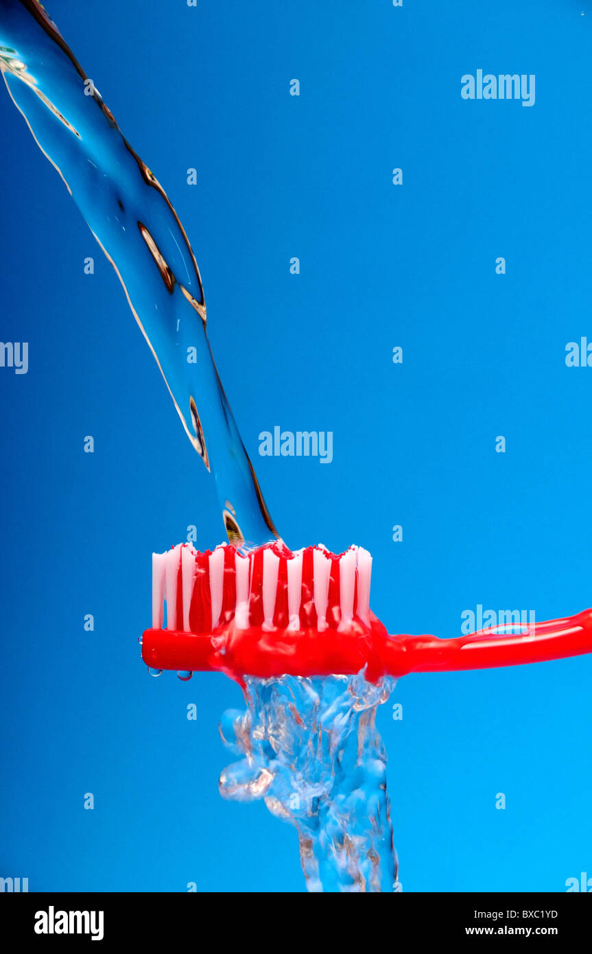 toothbrush with water falling on it Stock Photo