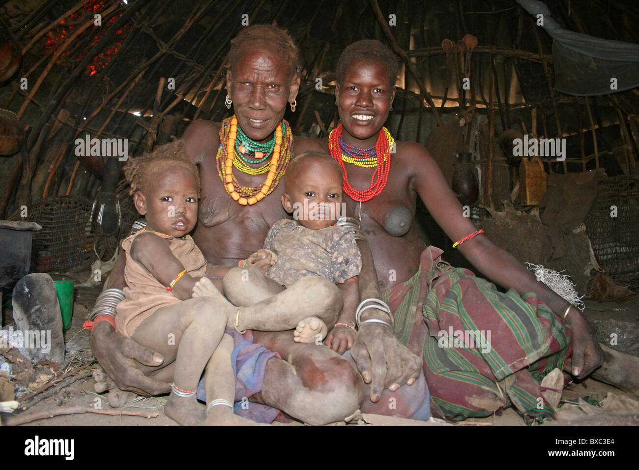 Three Generation Of A Dassanech Family, Omorate, Omo Valley, Ethiopia Stock Photo