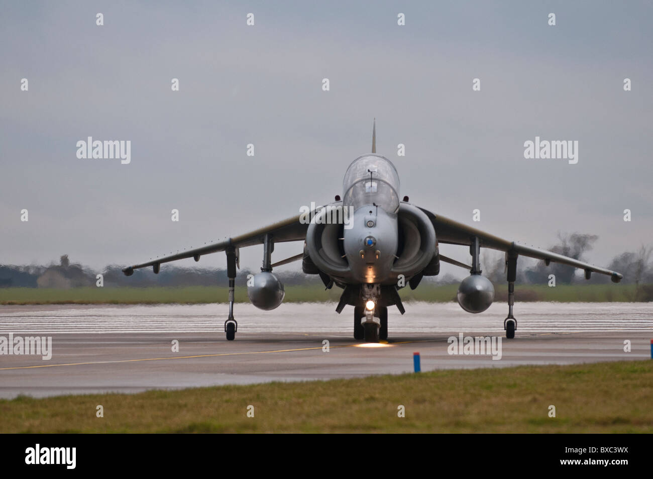 BAe Harrier T.12  VTOL jet ZH659  turns off the runway at Cottesmore after landing having completed its last operational flight. Stock Photo
