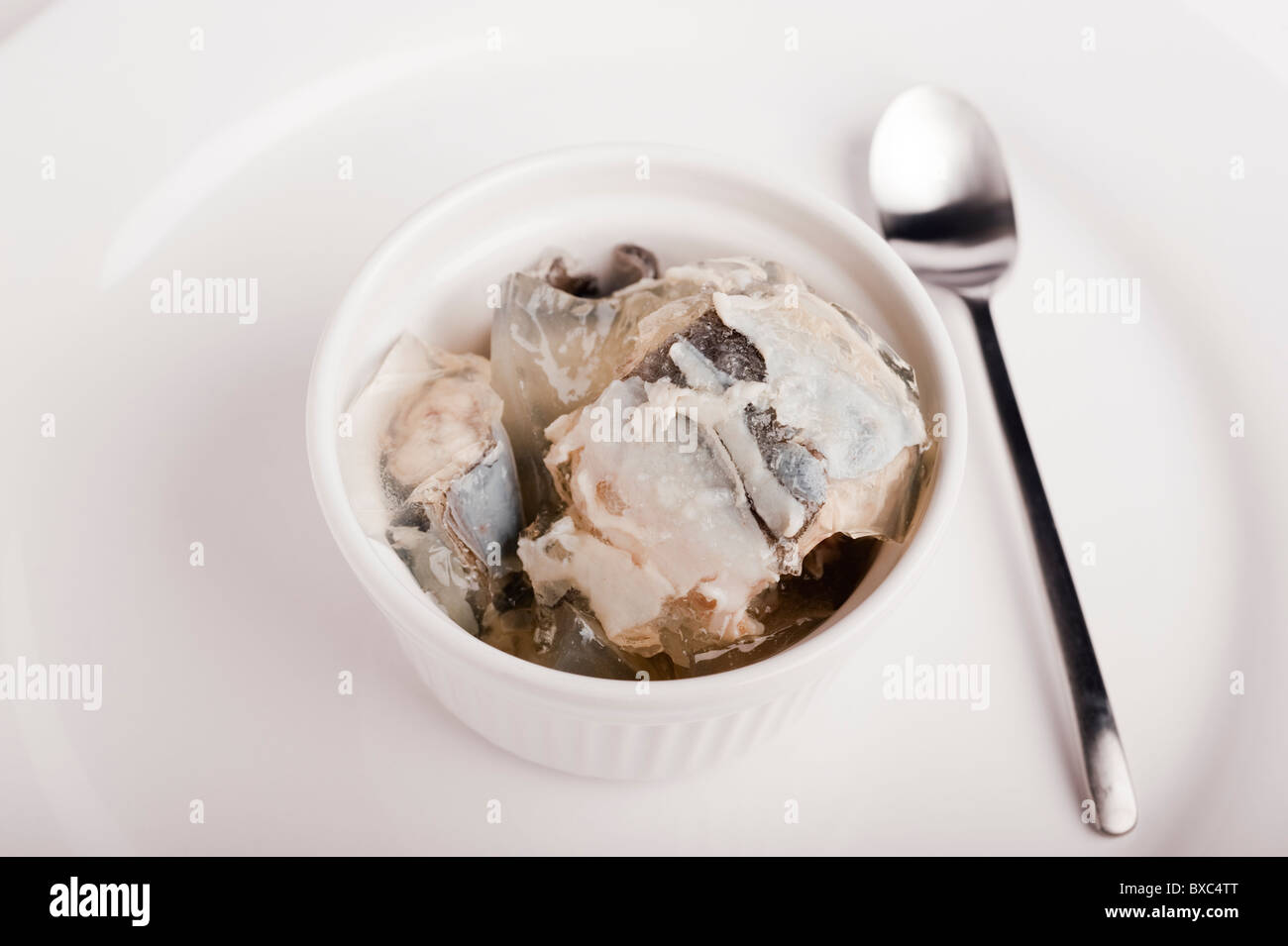 Tub Of Jellied Eels with a Spoon Stock Photo
