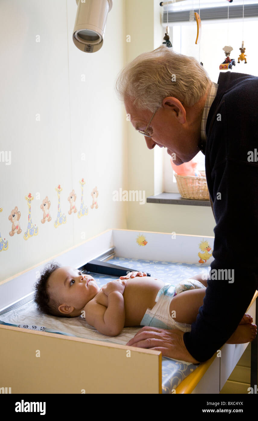 A healthy, six months old boy being examined at a childrens doctor