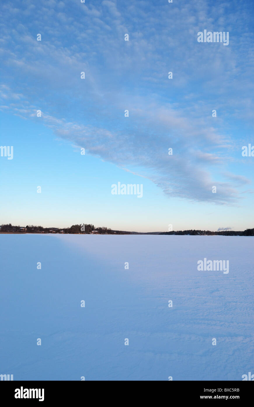 Winter evening on frozen lake Stock Photo - Alamy