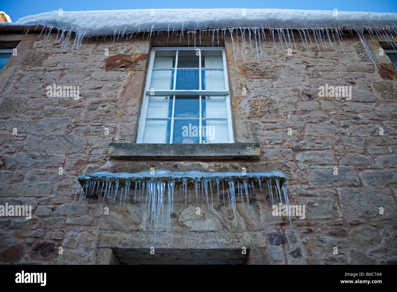 Icicles hanging from roof and window sill winter Edinburgh Scotland UK Europe Stock Photo