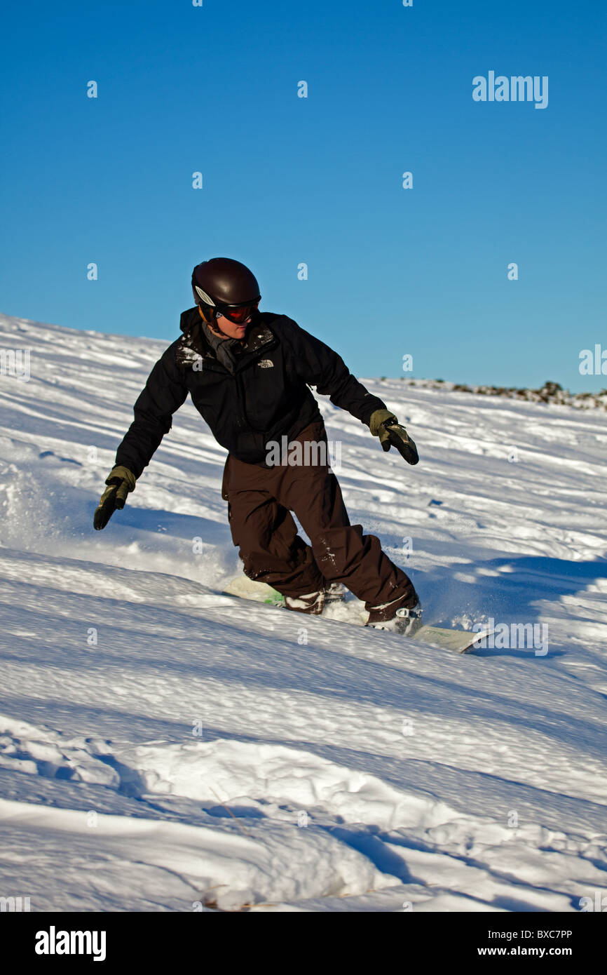 Snowboarder surrounded by snow, Arthurs Seat, Edinburgh Scotland UK Europe Stock Photo