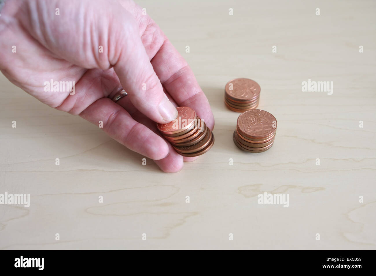 1p coins hand hi-res stock photography and images - Alamy