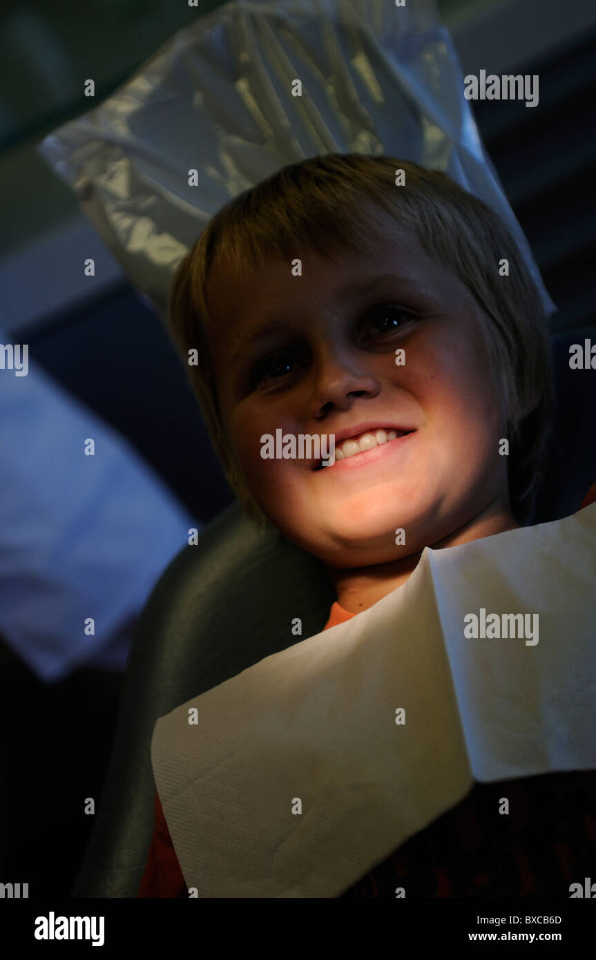 Stock photo of a 10 year old boy sitting in the Dentists chair. Stock Photo