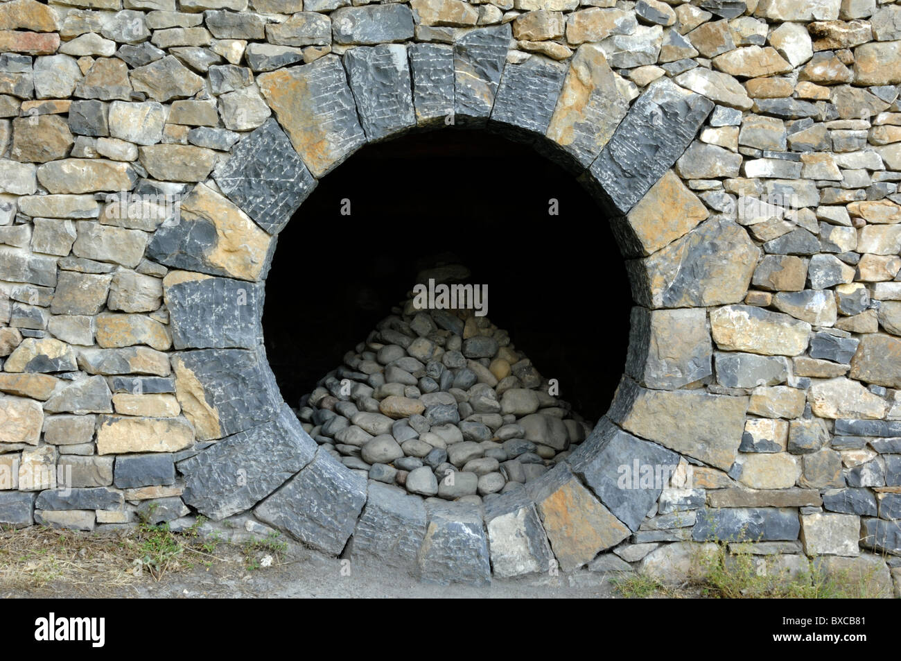 Refuge d'Art or Land Art by Andy Goldsworthy, or Dry Stone Hut with Circular Window, near the Thermes, Digne-les-Bains, Alpes-de-Haute-Provence France Stock Photo