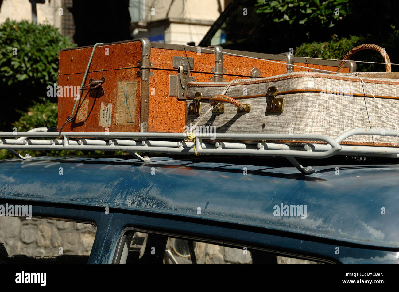 Vintage Luggage, Travel Trunk or Suitcases Tied to Old Roof Rack on Old Peugeot 403 Car, Forcalquier, Alpes-de-Haute-Provence, Provence France Stock Photo