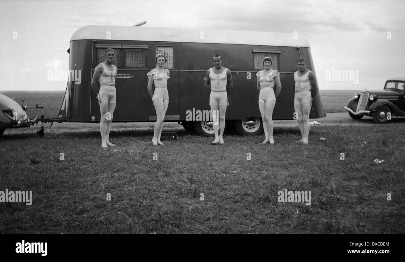 The Five Fearless Flyers circus trapeze act gather outside their travel trailer 1930s traveling fashion costumes physically fit Stock Photo