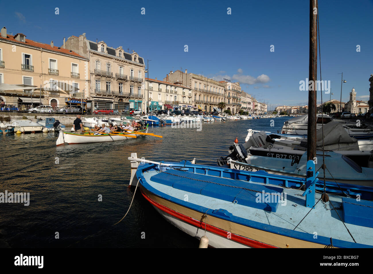 Colourful Wooden Fishing Boat & Tourists Rowing Down the Canal Royal & Quai de Tassigny, Sète, France Stock Photo