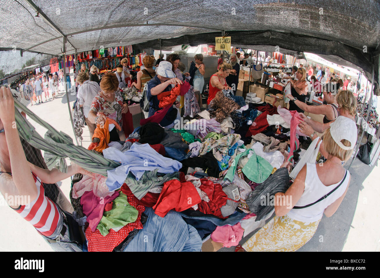 stall with cheap used clothing in spanish outdoor market Stock Photo
