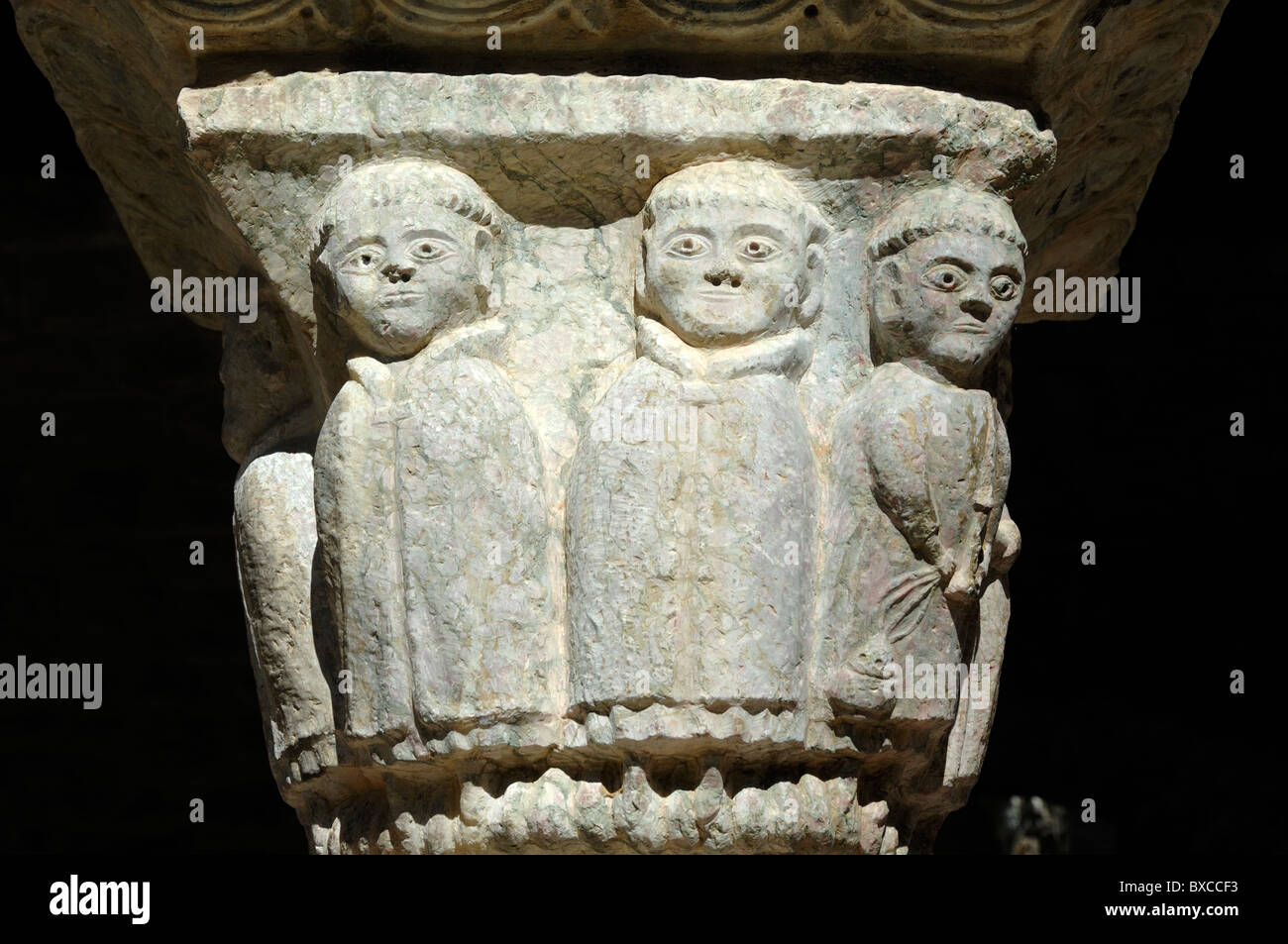 Carved Stone Tonsured Monks on Capital of the Cloisters, Saint-Martin-du-Canigou Abbey or Monastery, Casteil, Pyrenees or Pyrénéees-Orientales France Stock Photo