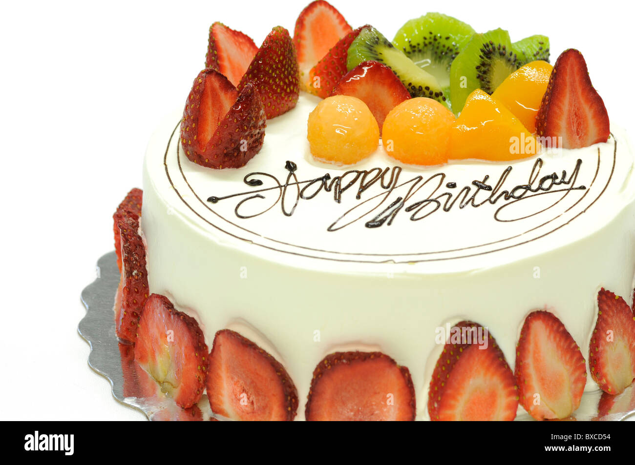 Tasty colorful fruit cake with happy birthday on it Stock Photo