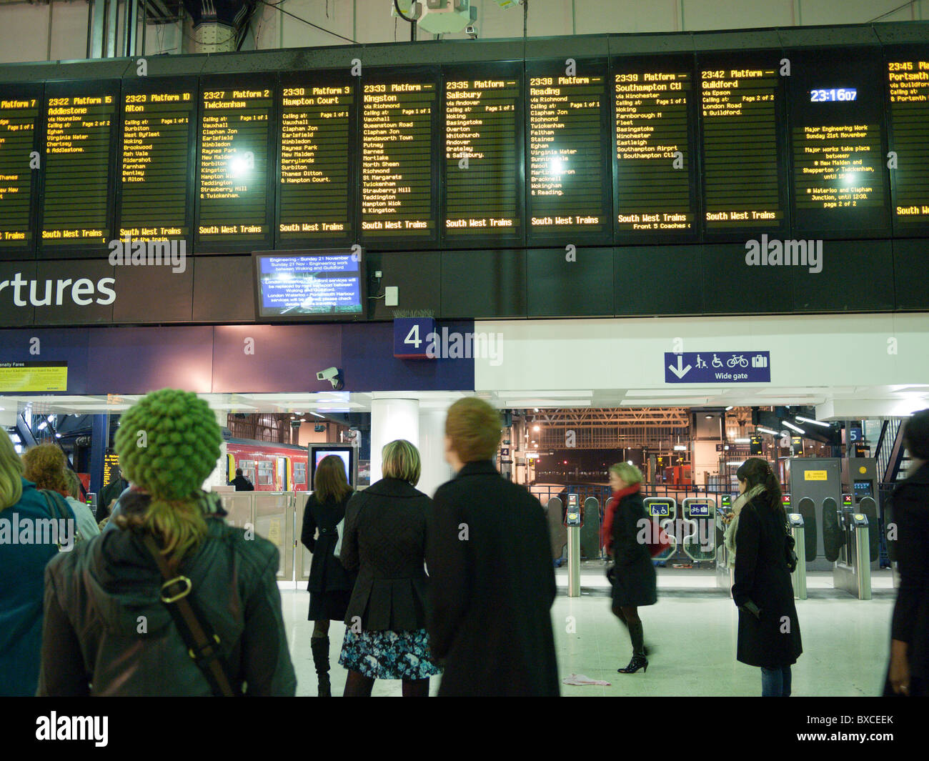 Travelers In Front Of The Electronic Time Table At Waterloo
