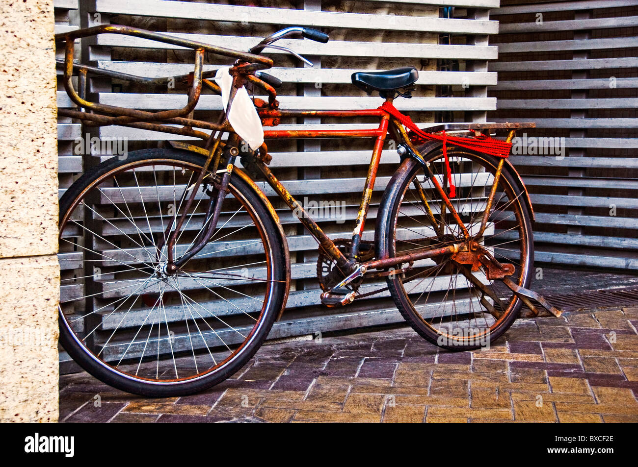 Old style bicycle parked on sidewalk Stock Photo