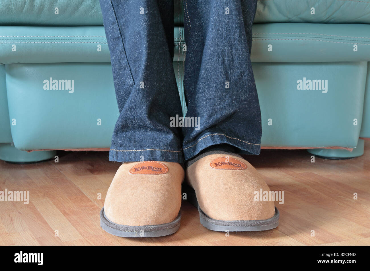 Man Wearing Sheepskin Comfy Slippers Whilst Sitting Down in a Leather ...