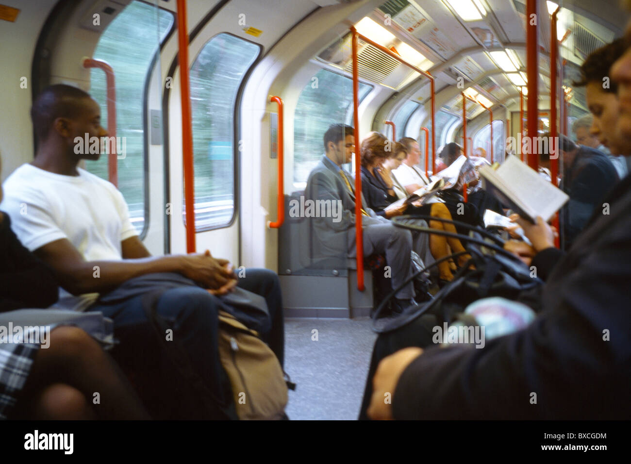 London Underground Train Interior People Reading Stock Photo - Alamy