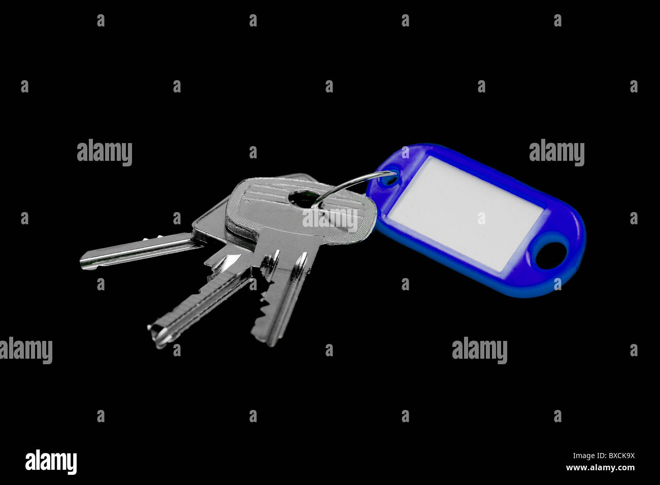 Bunch of keys with blank label isolated on black Stock Photo - Alamy