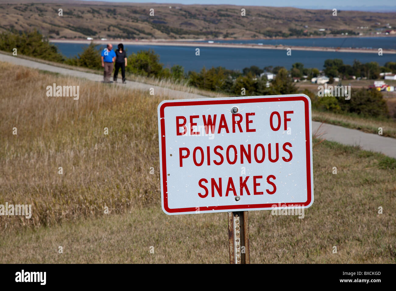 Sign Warns of Snakes on Trail at Highway Rest Area Stock Photo