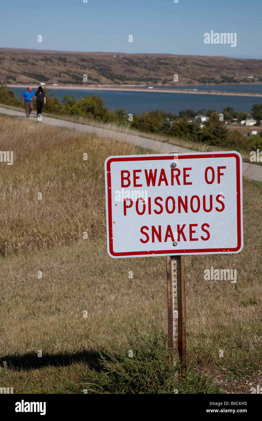 Sign Warns of Snakes on Trail at Highway Rest Area Stock Photo