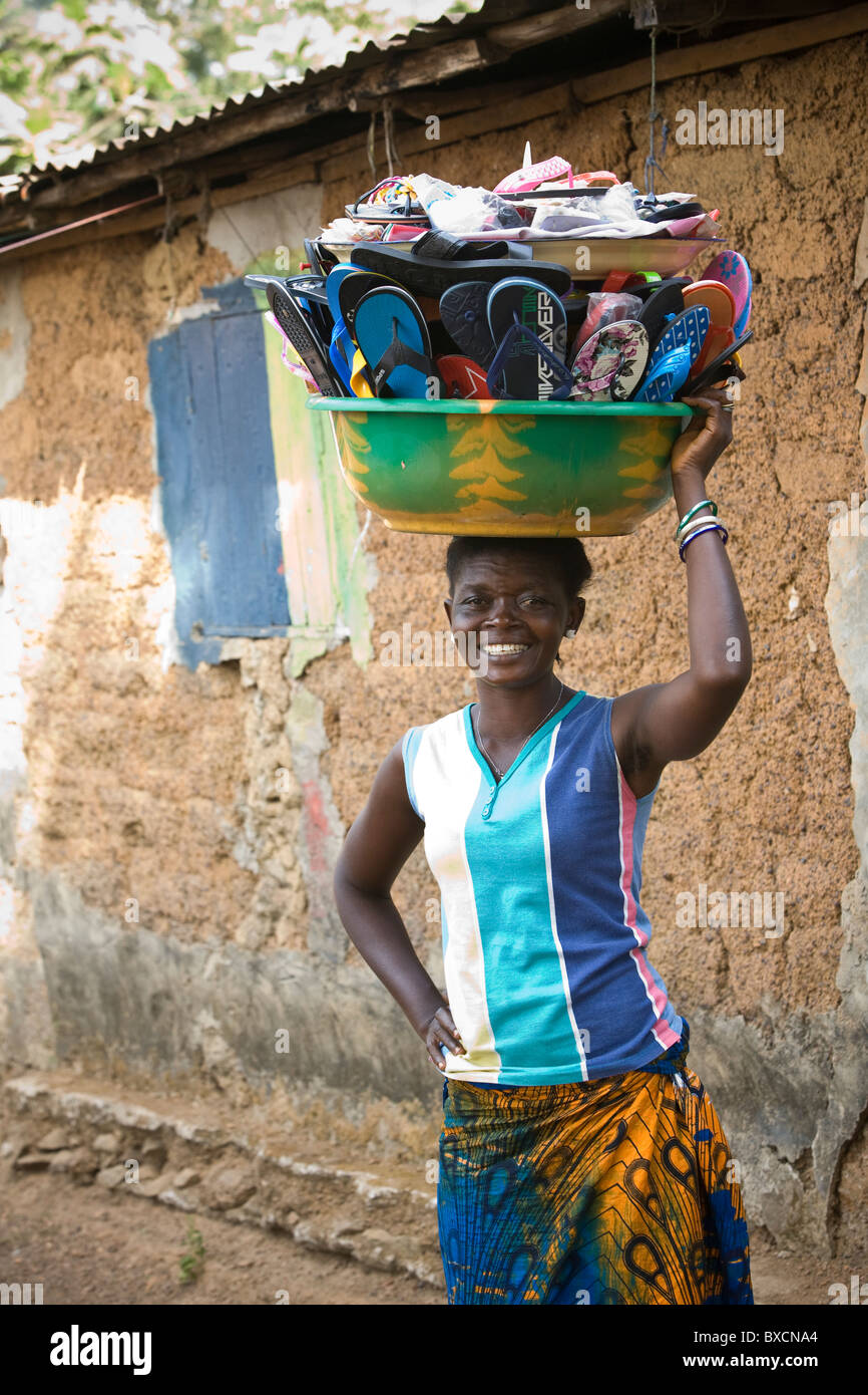 Ms. Maria Jafon used microfinance loan to get her shoe selling business started in Freetown, Sierra Leone. Stock Photo