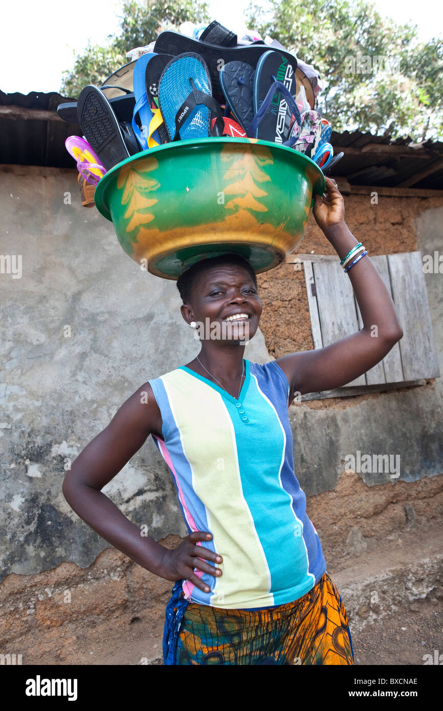 Ms. Maria Jafon used microfinance loan to get her shoe selling business started in Freetown, Sierra Leone. Stock Photo