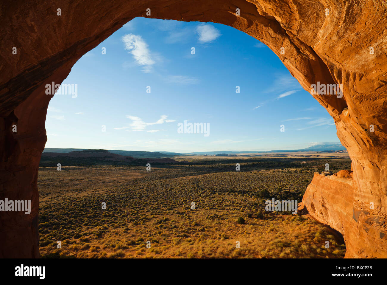 A view at sunrise looking out from Looking Glass Arch in Southeast Utah, USA. Stock Photo