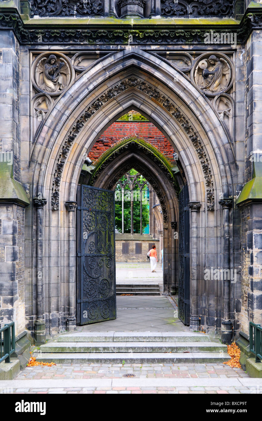 A side gate into the ruins of the Gothic Revival Church of St. Nicholas (St.-Nikolai-Kirche) in Hamburg, Germany. Stock Photo