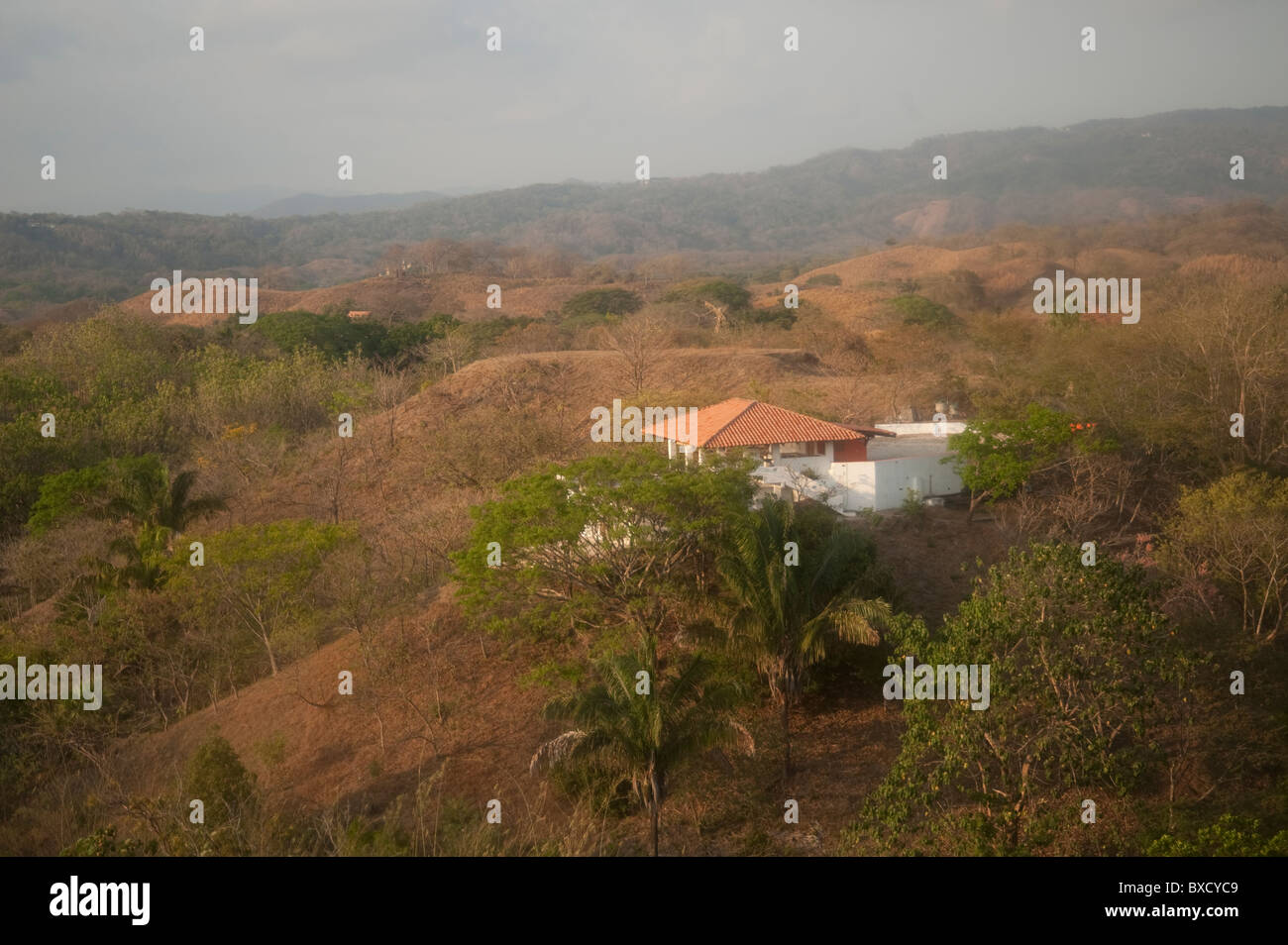 Solitary white house with an orange roof in the hilltops of Costa Rica Stock Photo