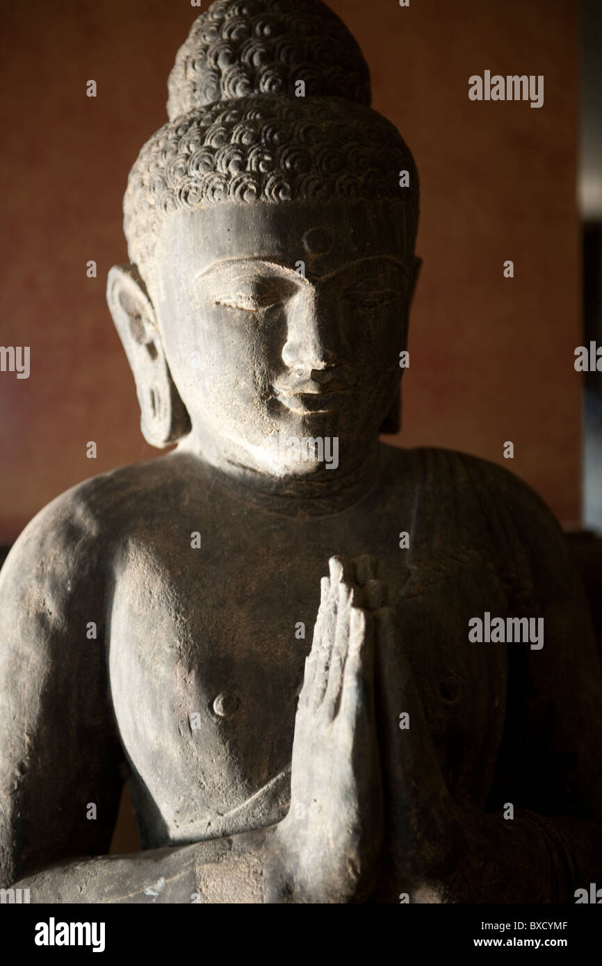 Buddha statue hands in prayer position hires stock photography and