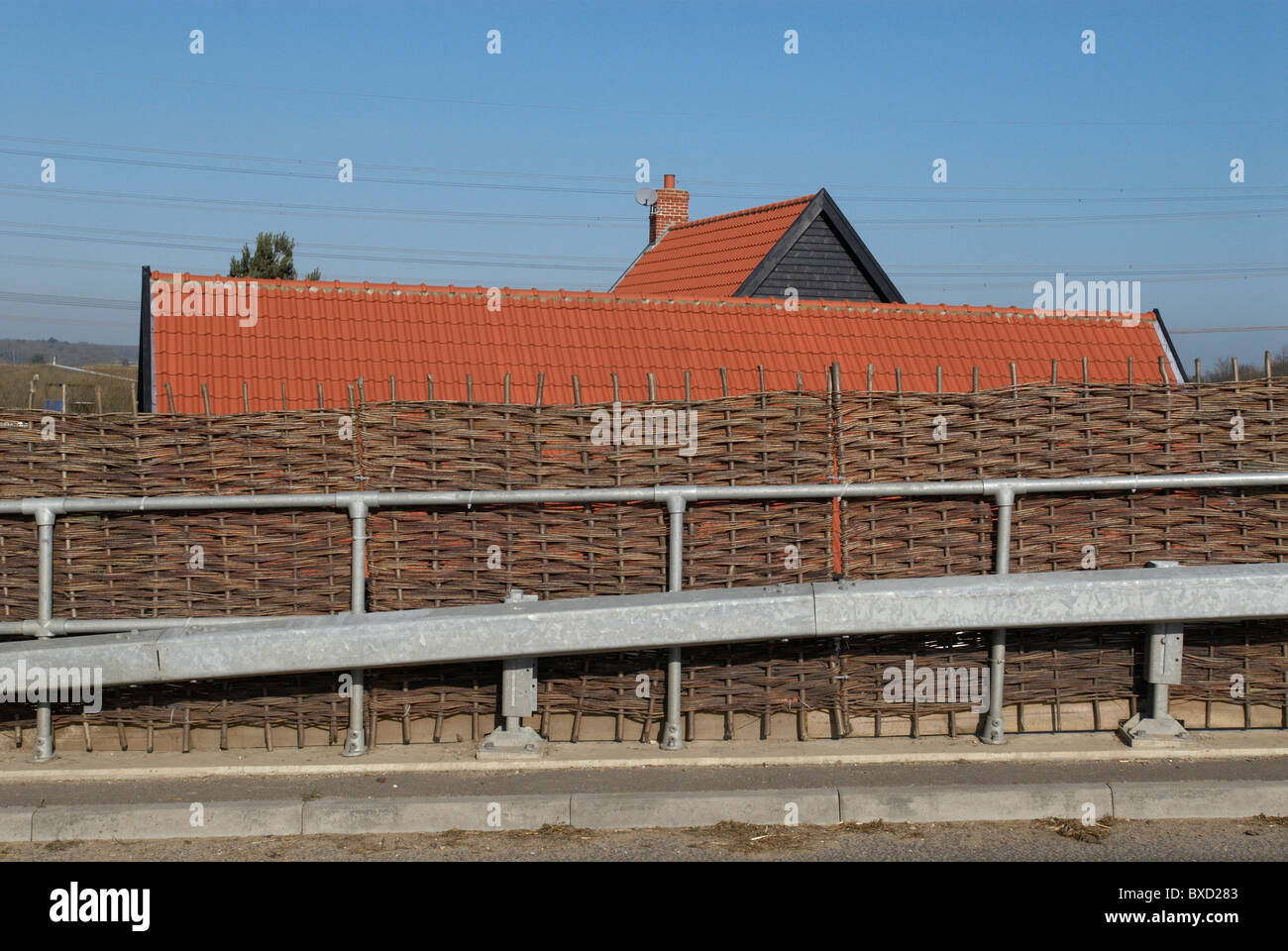 Willow fencing on a roadside acting as a protective barrier Stock Photo