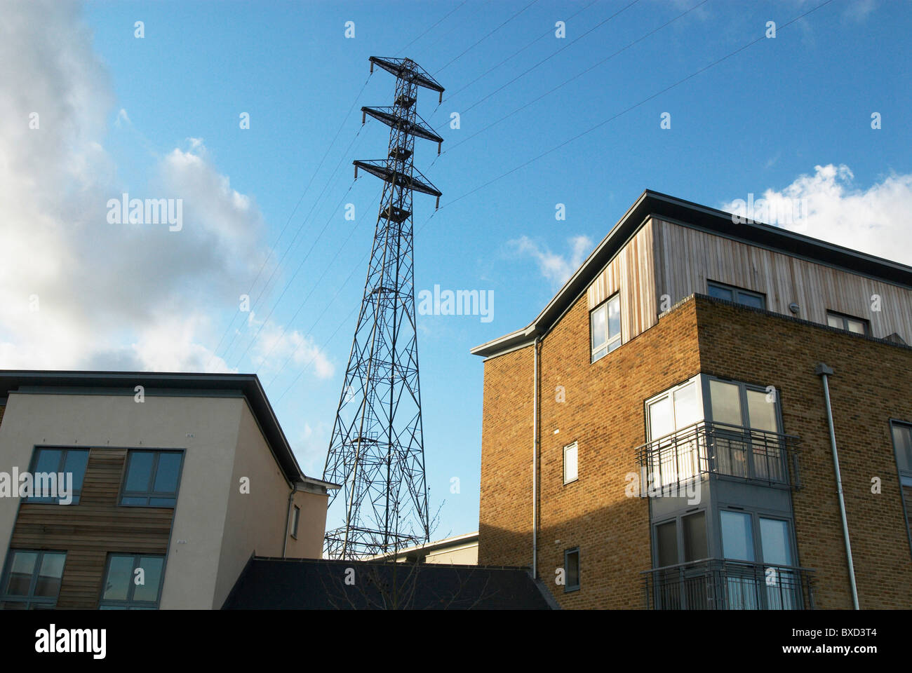 Electric pylon towering over new housing development Colchester UK