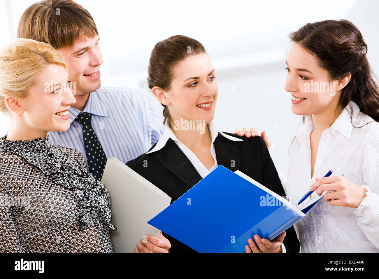 Group of four people interacting at business meeting Stock Photo - Alamy