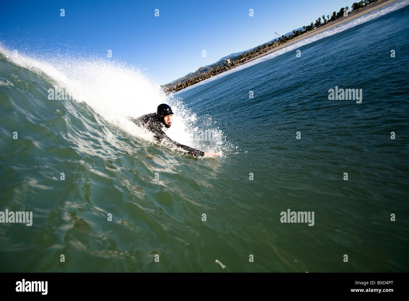 A male bodysurfer drops into a wave. Stock Photo