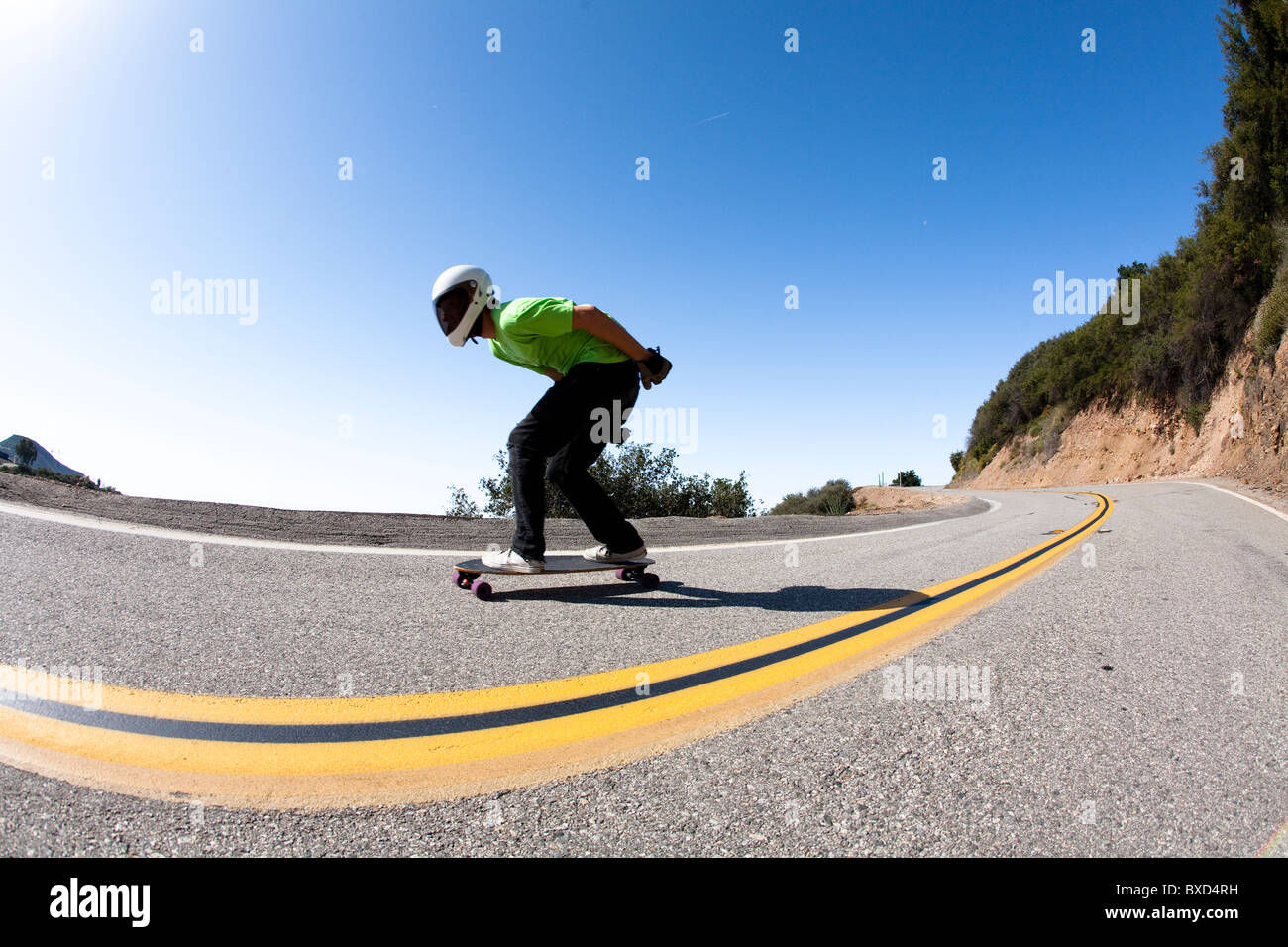 A downhill skateboarder rides down a steep mountain Stock Photo Alamy