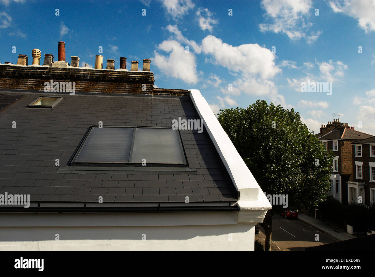 Solar panels on roof of Victorian house Camden Town London UK Stock Photo
