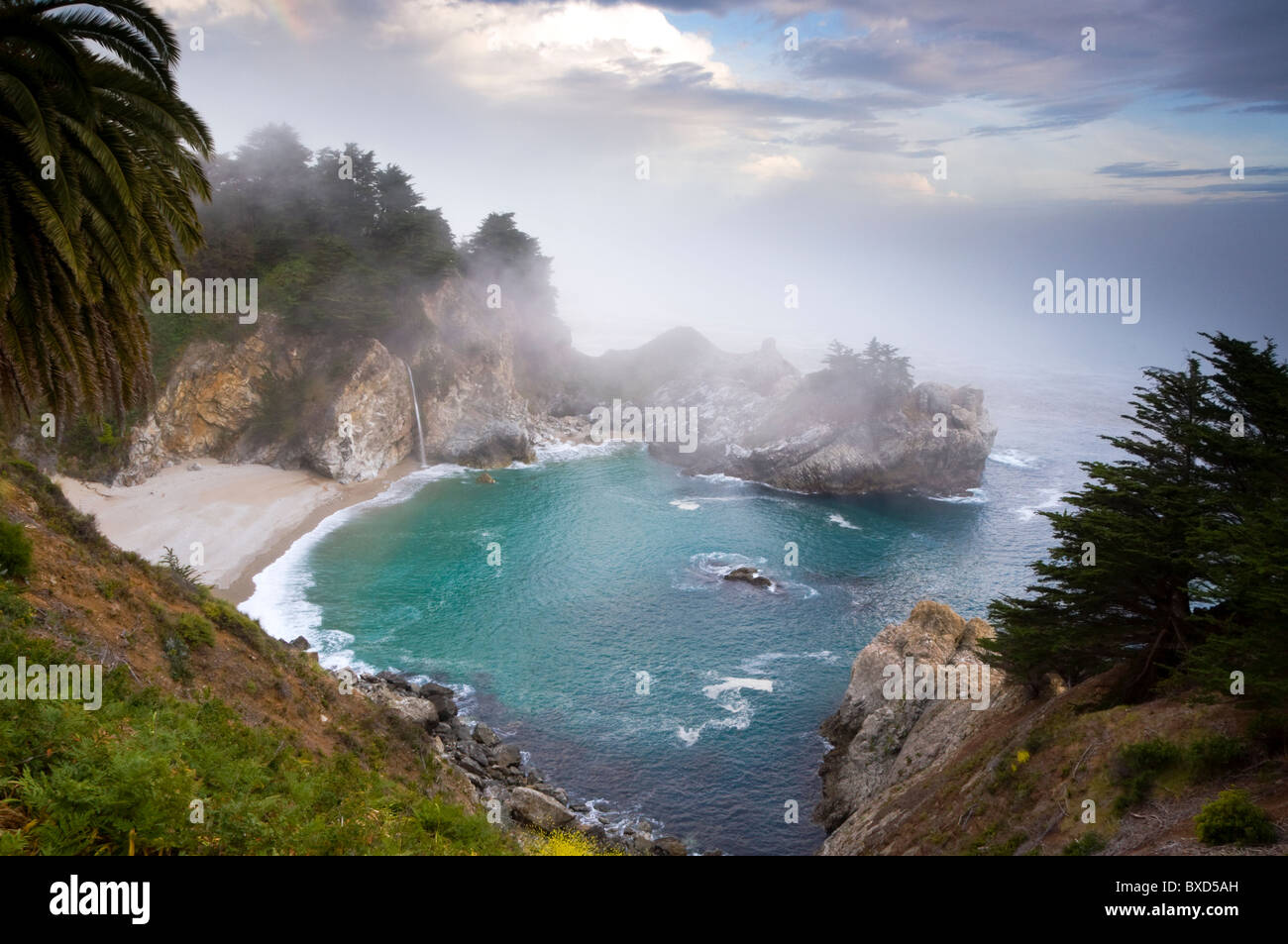 Fog rolls in at the classic Big Sur overlook in Julia Pfeiffer Burns State Park in California. Stock Photo